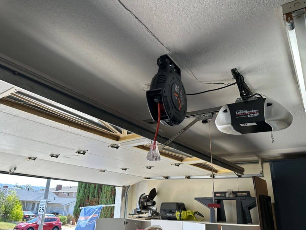 Retractable cord reel ceiling mount with garage open